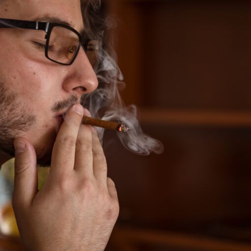 Young Man is Relaxing with Cigarette